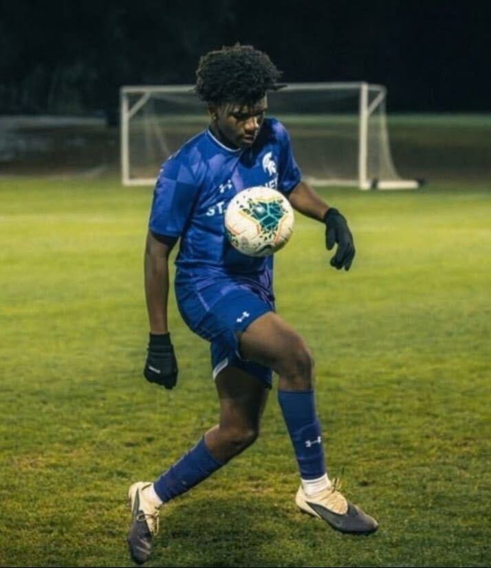 Ajani Carnegie controlling a football during an evening training session.